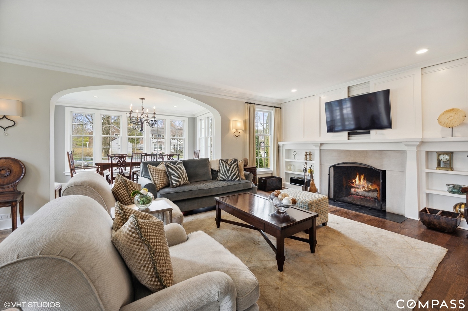 460 Berkeley Avenue Winnetka, IL 60093 - Photo 9 of 45 a living room with furniture a flat screen tv and a fireplace