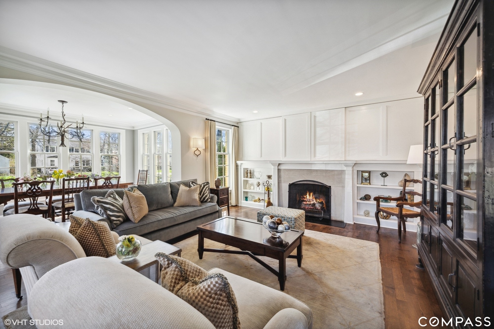 460 Berkeley Avenue Winnetka, IL 60093 - Photo 10 of 45 a living room with furniture a fireplace and a chandelier