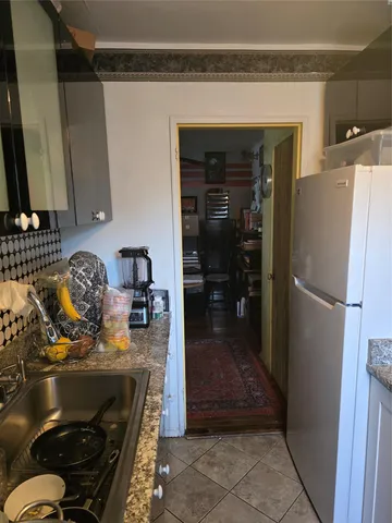 a kitchen with a refrigerator and a stove