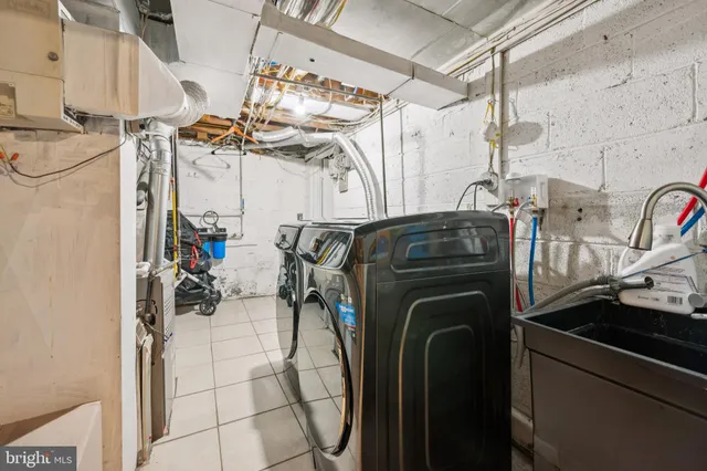 a utility room with multiple dryer and washer