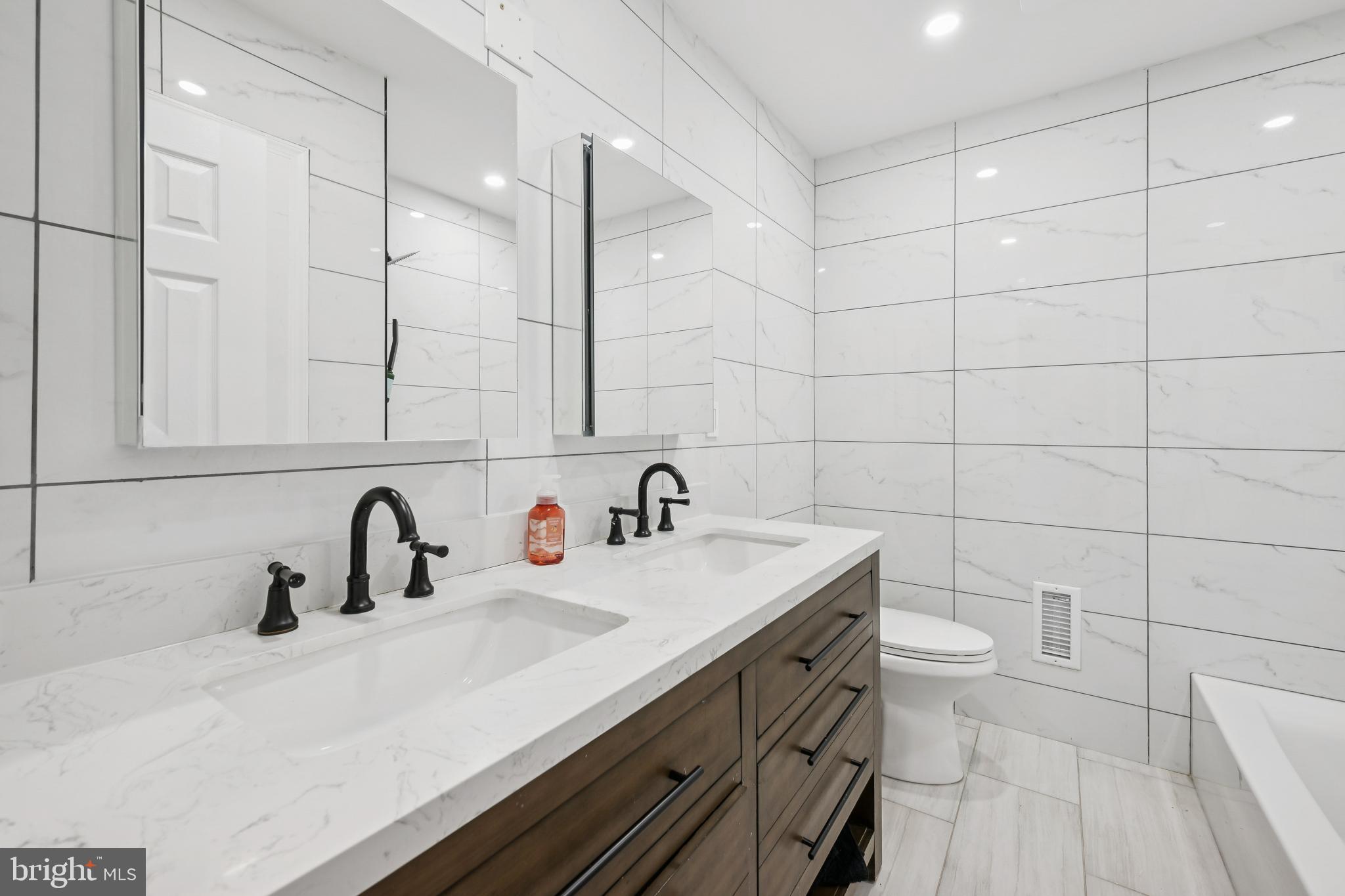 9810 Bridle Road Philadelphia, PA 19115 - Photo 18 of 25 a bathroom with a sink and a mirror