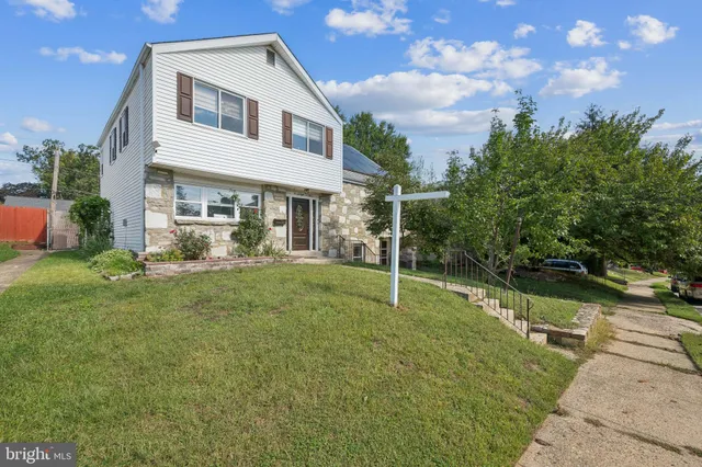 a view of a house with a backyard and a patio