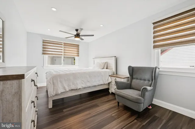 a bedroom with a bed couch and a window