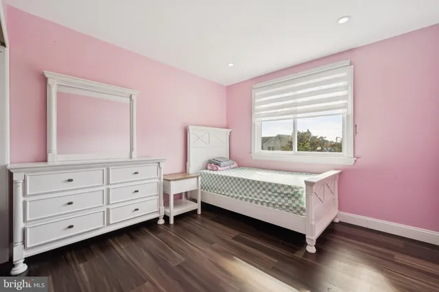 a living room with baby crib furniture and a window