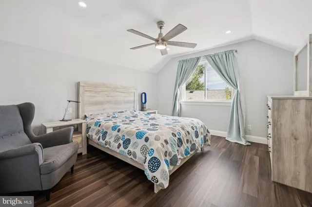 a bedroom with a bed couch and window