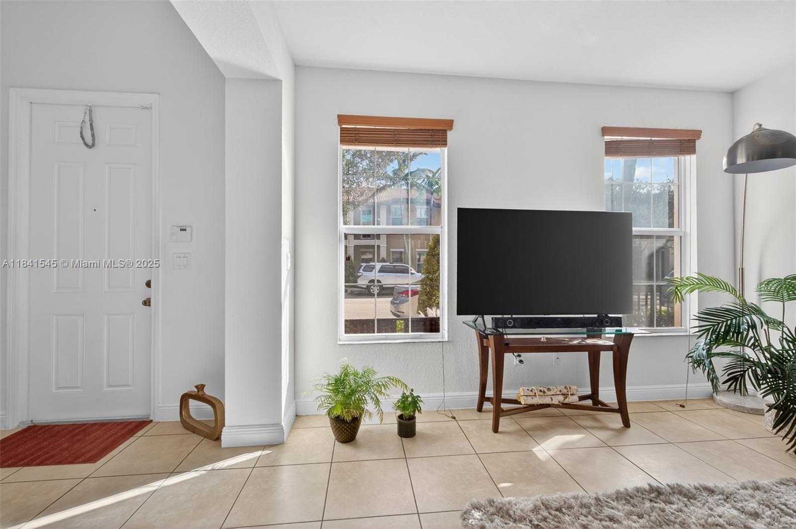 14615 Southwest 14 Street, Unit 14615 Pembroke Pines, FL 33027 - Photo 11 of 49 a living room with furniture and a flat screen tv