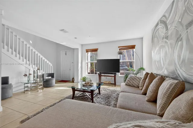 a living room with furniture and a flat screen tv