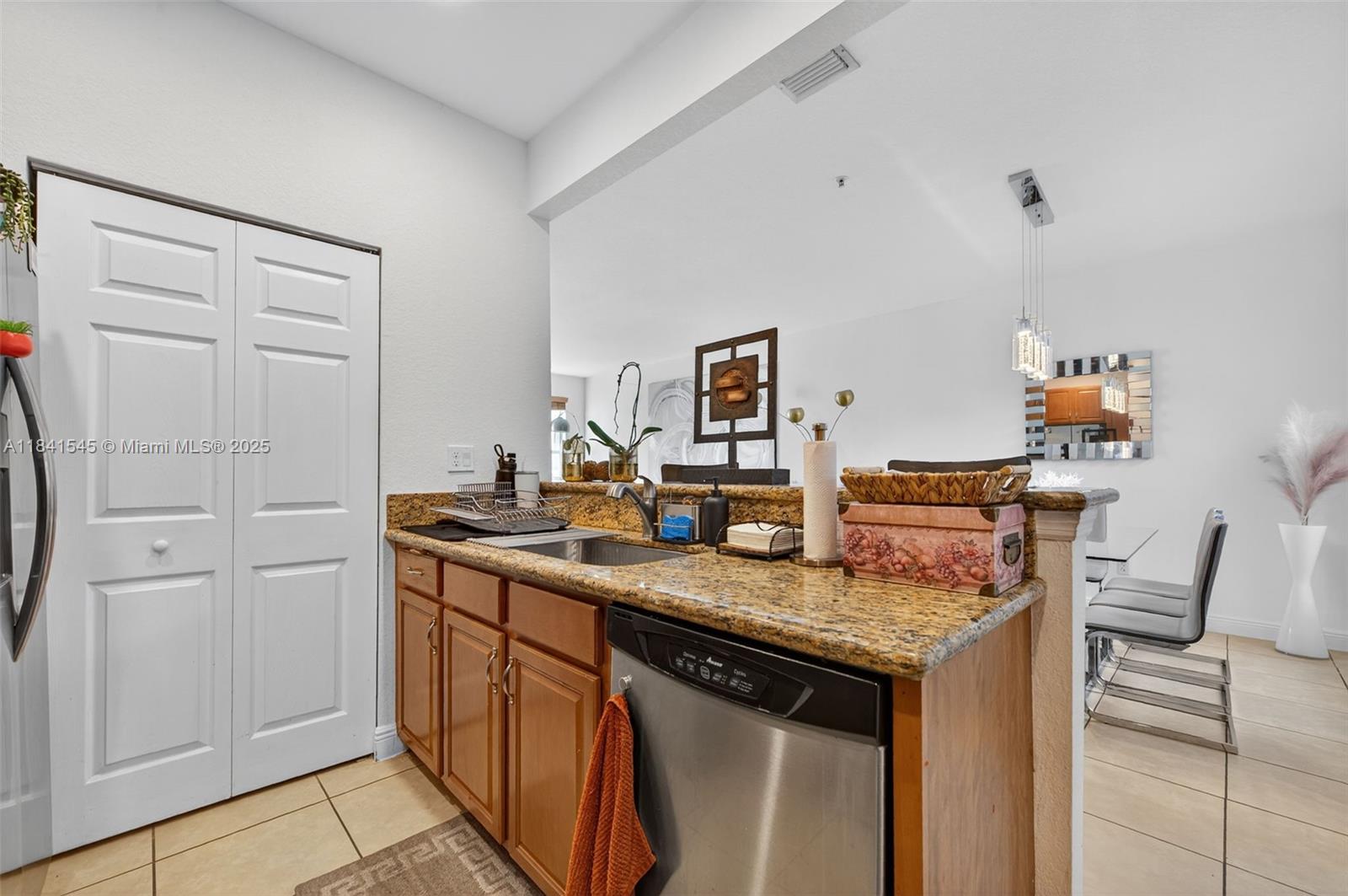 14615 Southwest 14 Street, Unit 14615 Pembroke Pines, FL 33027 - Photo 18 of 49 a kitchen with a sink and cabinets