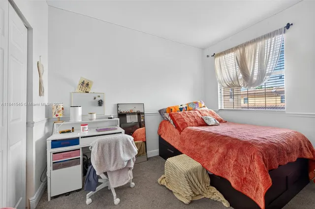 a bed room with a bed and a chair