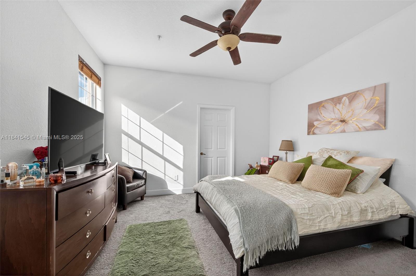 14615 Southwest 14 Street, Unit 14615 Pembroke Pines, FL 33027 - Photo 27 of 49 a bedroom with a bed and a flat screen tv