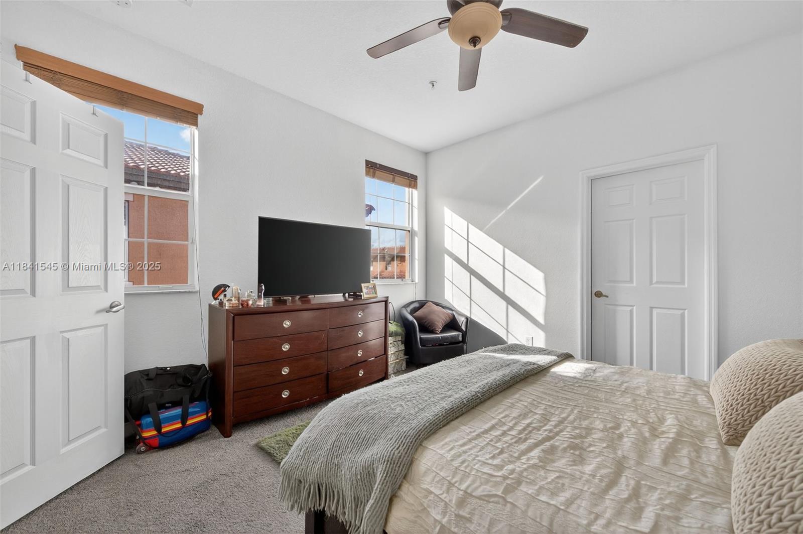 14615 Southwest 14 Street, Unit 14615 Pembroke Pines, FL 33027 - Photo 28 of 49 a bedroom with a bed and a flat screen tv