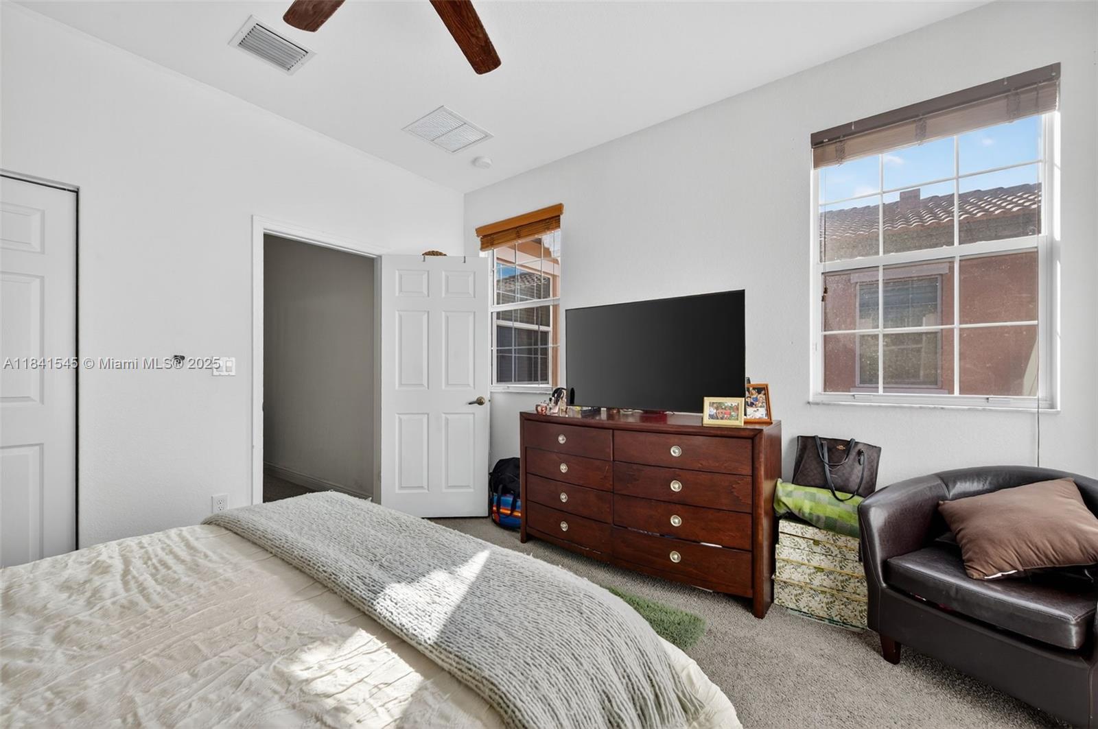 14615 Southwest 14 Street, Unit 14615 Pembroke Pines, FL 33027 - Photo 29 of 49 a bedroom with a bed and a television