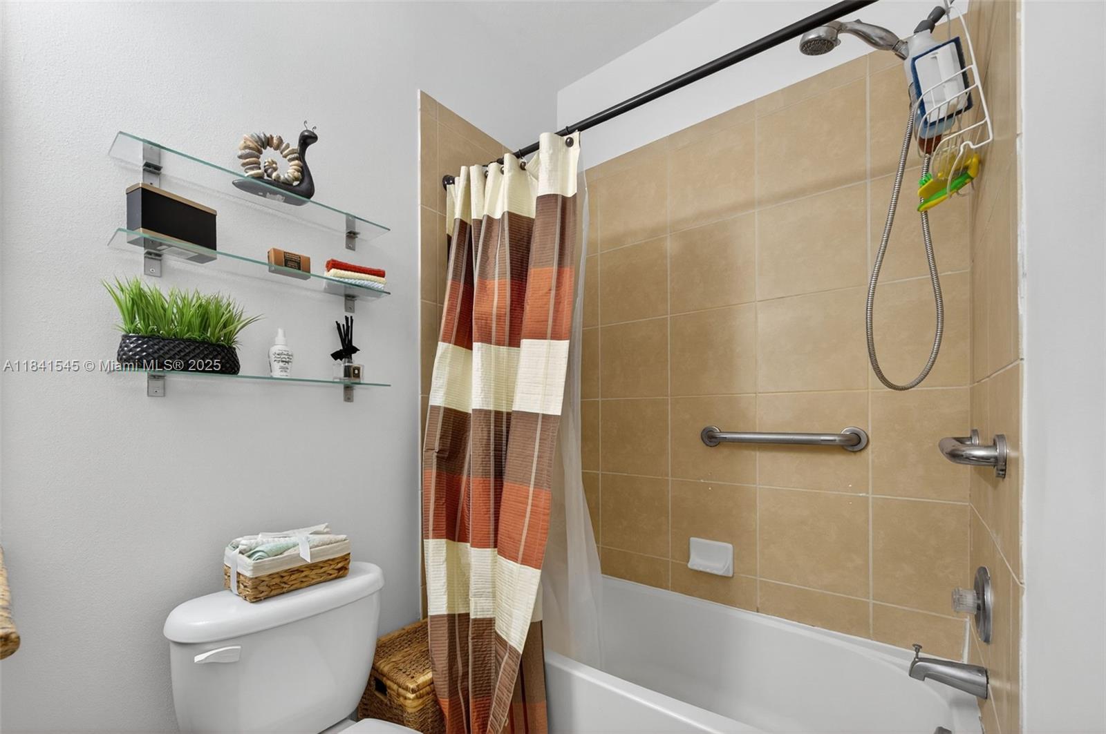 14615 Southwest 14 Street, Unit 14615 Pembroke Pines, FL 33027 - Photo 32 of 49 a bathroom with a shower a toilet and a shower