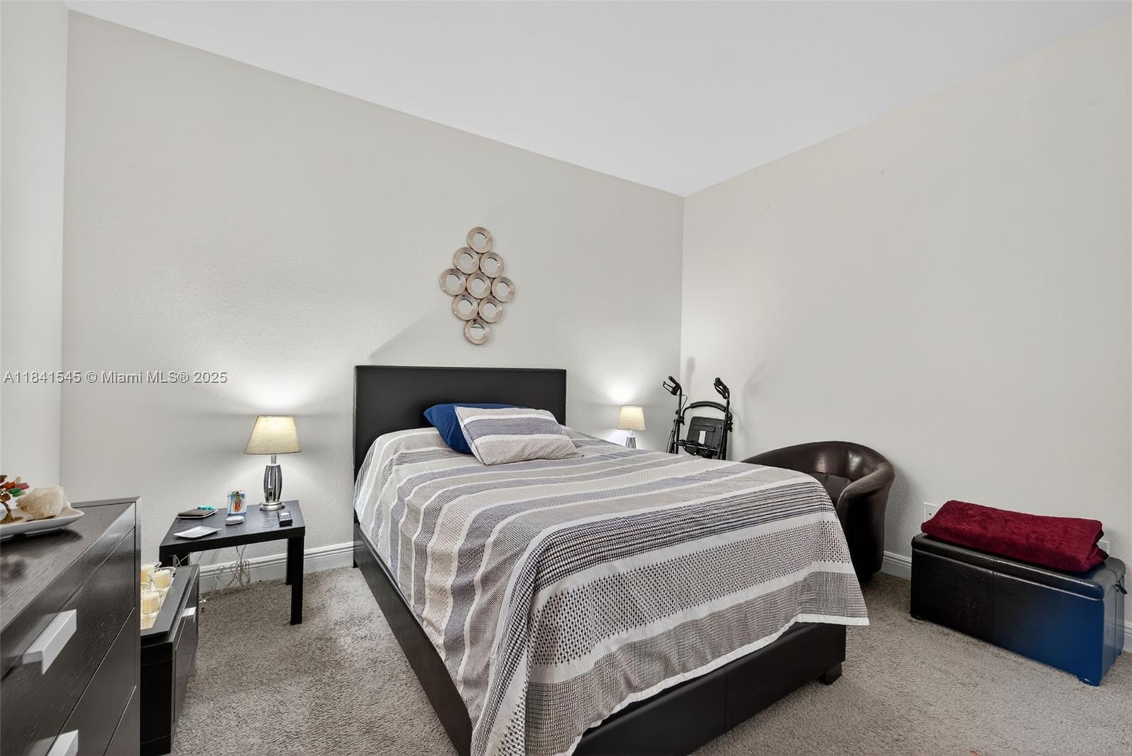 14615 Southwest 14 Street, Unit 14615 Pembroke Pines, FL 33027 - Photo 33 of 49 a bedroom with a bed and a lamp on dresser