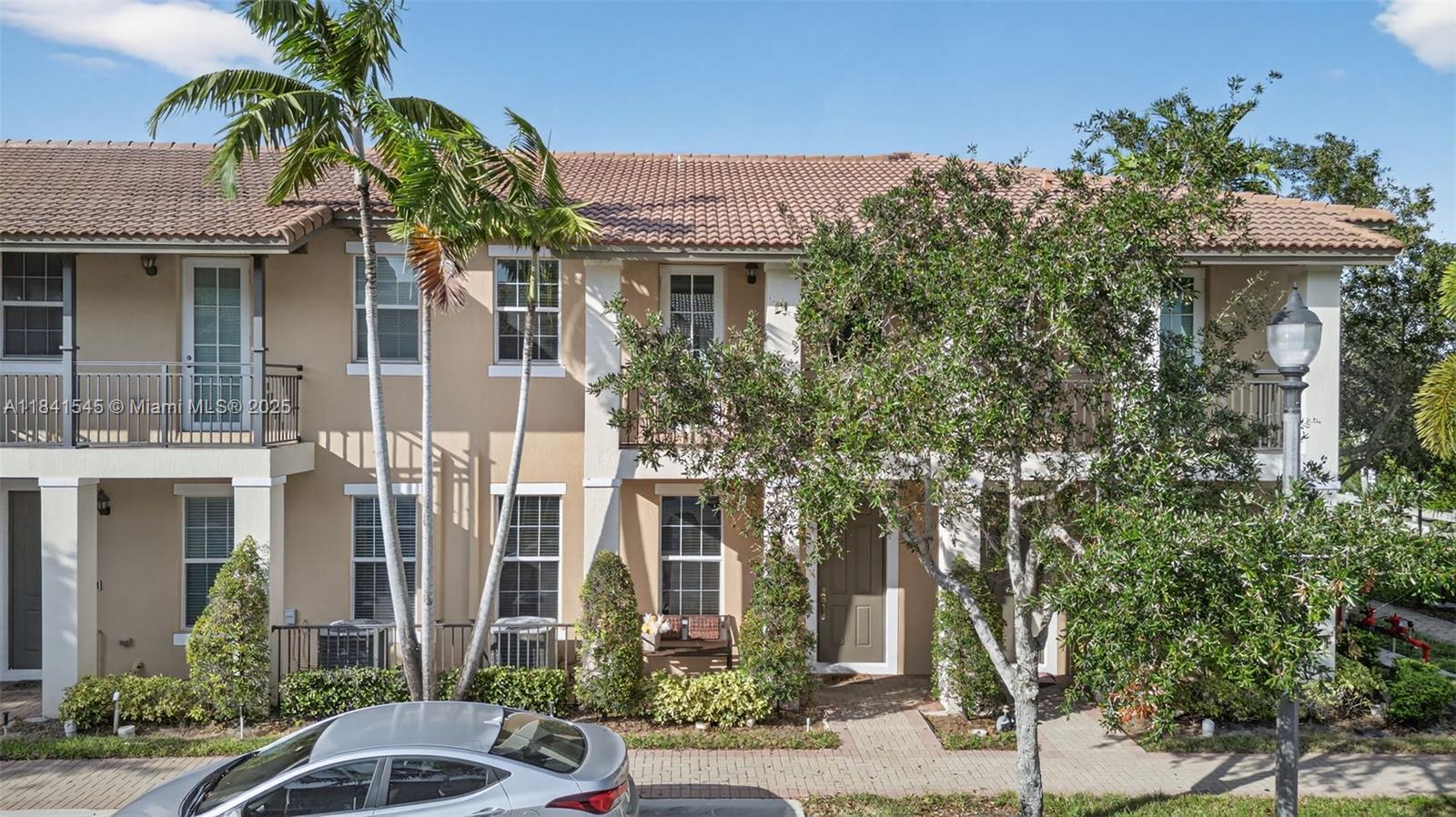 14615 Southwest 14 Street, Unit 14615 Pembroke Pines, FL 33027 - Photo 38 of 49 a front view of a house with a yard
