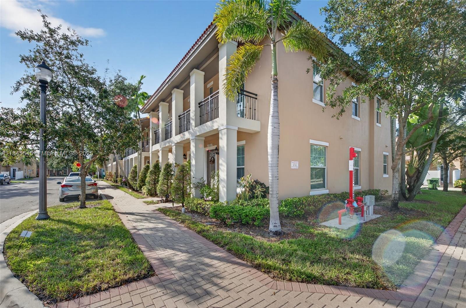 14615 Southwest 14 Street, Unit 14615 Pembroke Pines, FL 33027 - Photo 8 of 49 a front view of a house with a yard