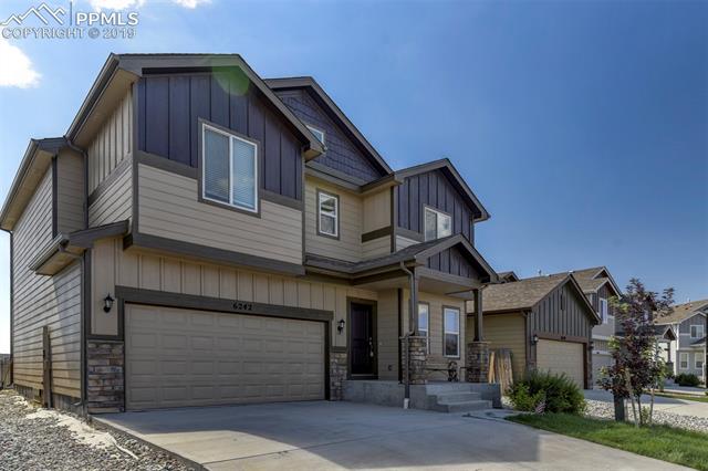 6242 Pilgrimage Road Colorado Springs, CO 80925 - Photo 3 of 7 2 car attached garage and a covered entry to the home!