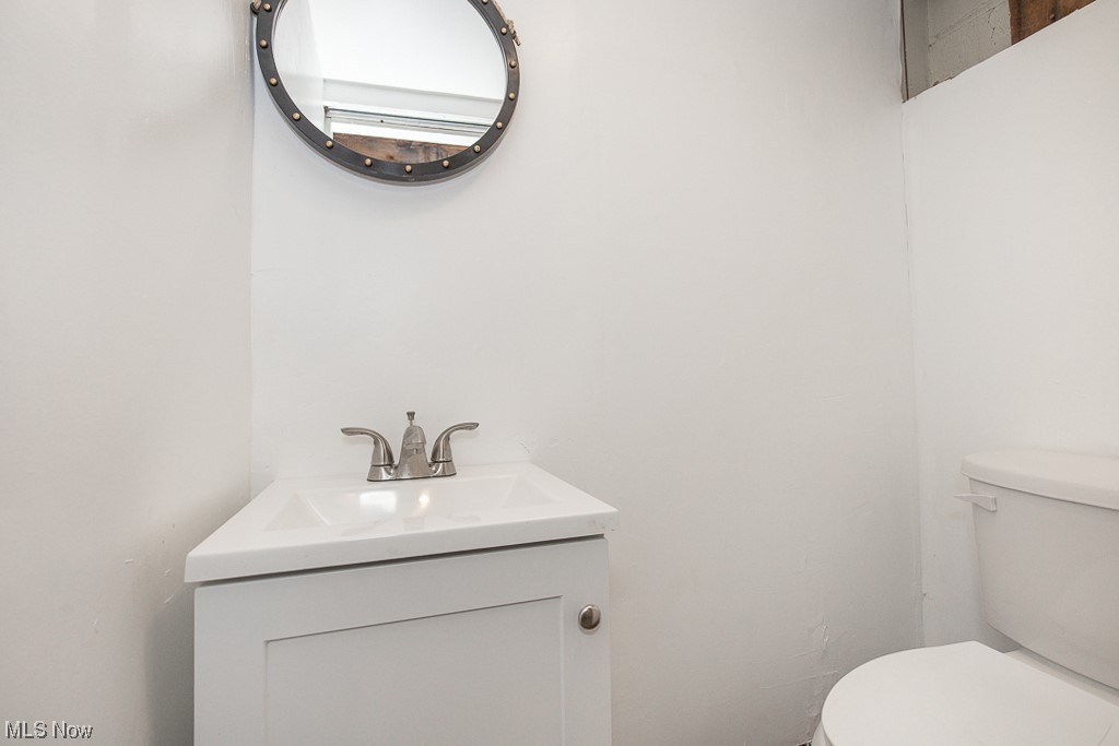 19109 Libby Road Maple Heights, OH 44137 - Photo 23 of 32 Bathroom featuring toilet and vanity with extensive cabinet space
