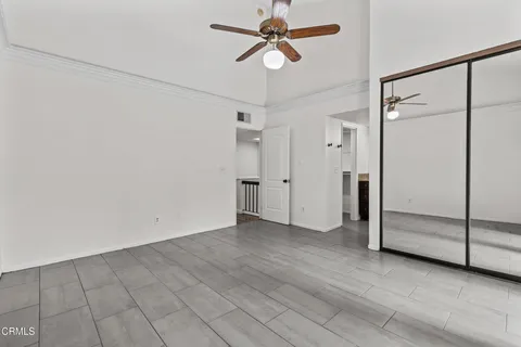 a view of empty room with wooden floor