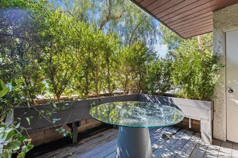 a view of a backyard with plants and brick wall