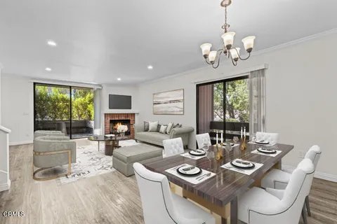 a living room with fireplace furniture and a large window