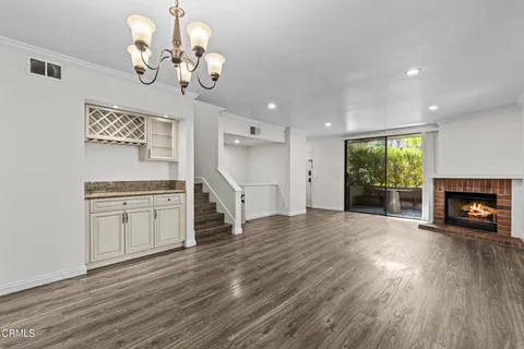 a view of a room with stove and wooden floor