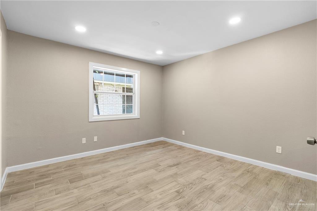 712 Toronto Avenue McAllen, TX 78503 - Photo 11 of 13 a view of empty room with wooden floor and fan