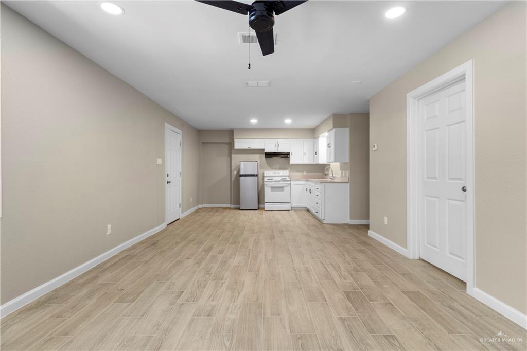 712 Toronto Avenue McAllen, TX 78503 - Photo 6 of 13 a view of a kitchen with a sink and dishwasher a refrigerator with wooden floor