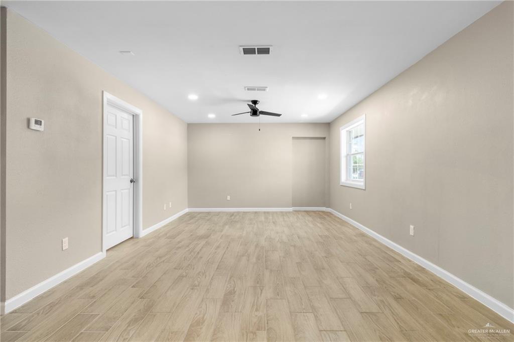 712 Toronto Avenue McAllen, TX 78503 - Photo 7 of 13 wooden floor in an empty room with a window