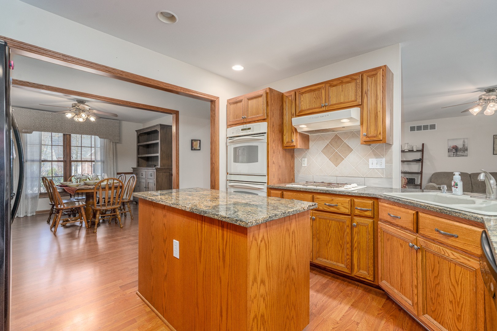 1715 Willow Road Morris, IL 60450 - Photo 5 of 22 a view of a kitchen counter top space with granite countertop wooden floor and living room