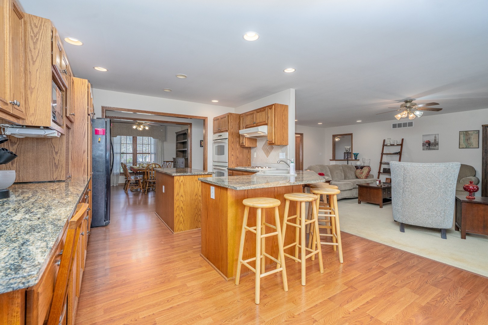 1715 Willow Road Morris, IL 60450 - Photo 7 of 22 a dining hall with stainless steel appliances granite countertop a stove and a wooden floors