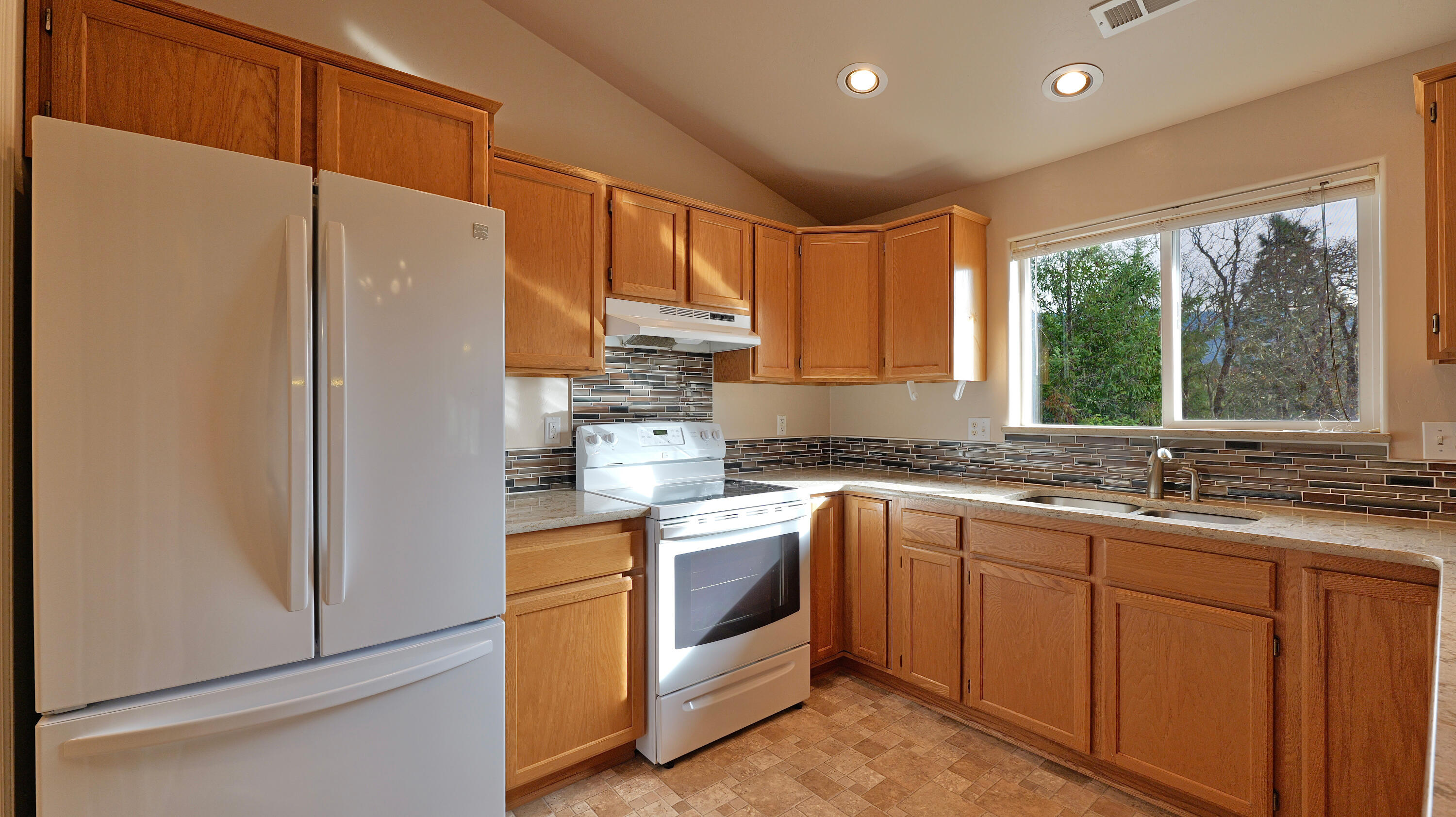 204 Shipley Terrace Prospect, OR 97536 - Photo 10 of 61 a kitchen with a sink a window and stainless steel appliances