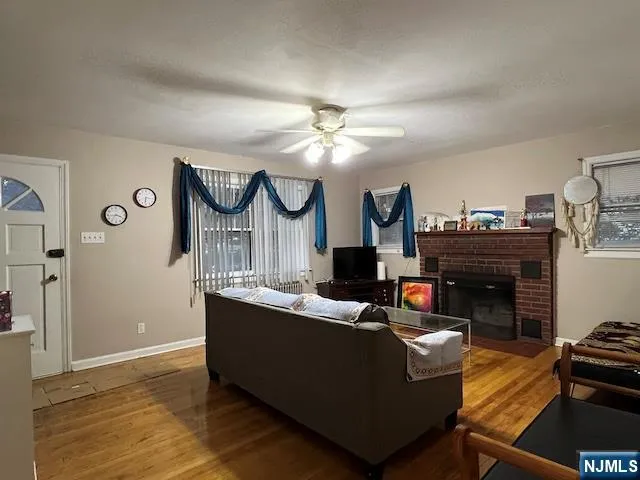 a living room with furniture a fireplace and a chandelier
