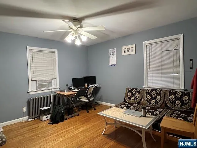 a view of a workspace with furniture and a window
