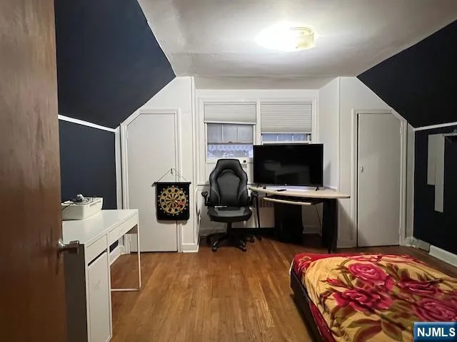 a bedroom with furniture and a flat screen tv