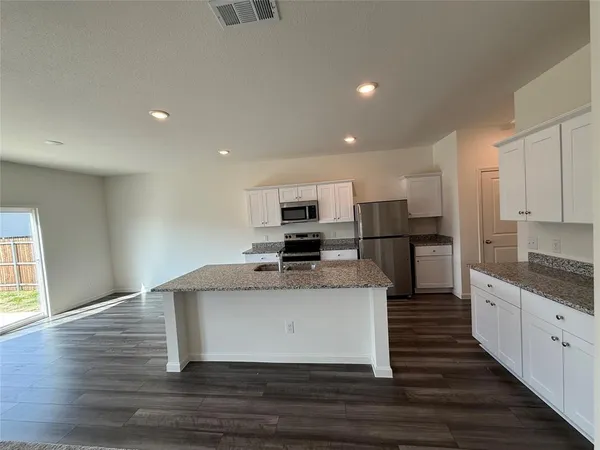 a view of kitchen with sink microwave and stove