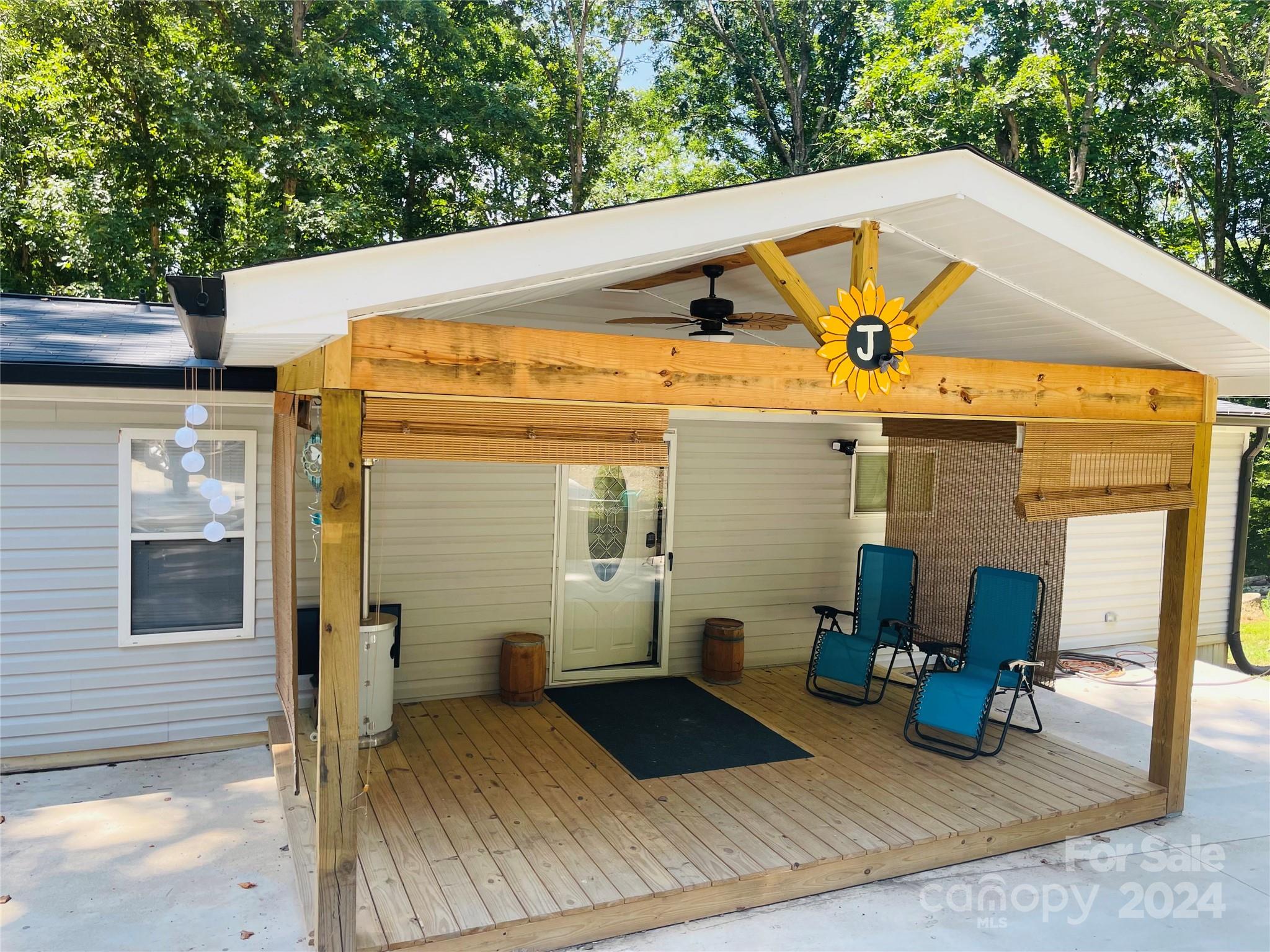 191 Old Hearth Road, Unit 29 Clover, SC 29710 - Photo 1 of 21 a view of a patio with table and chairs with wooden fence and plants