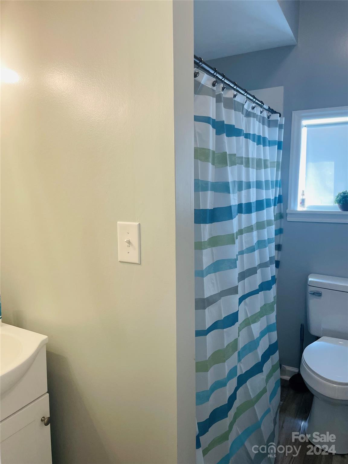 191 Old Hearth Road, Unit 29 Clover, SC 29710 - Photo 17 of 21 a bathroom with a toilet and a shower curtain