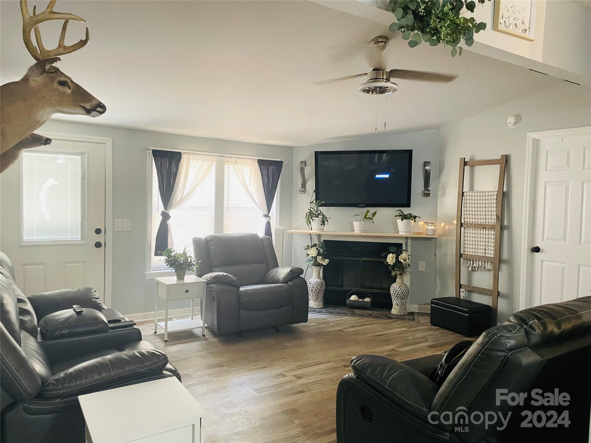 191 Old Hearth Road, Unit 29 Clover, SC 29710 - Photo 5 of 21 a living room with furniture a fireplace a flat screen tv and a large window