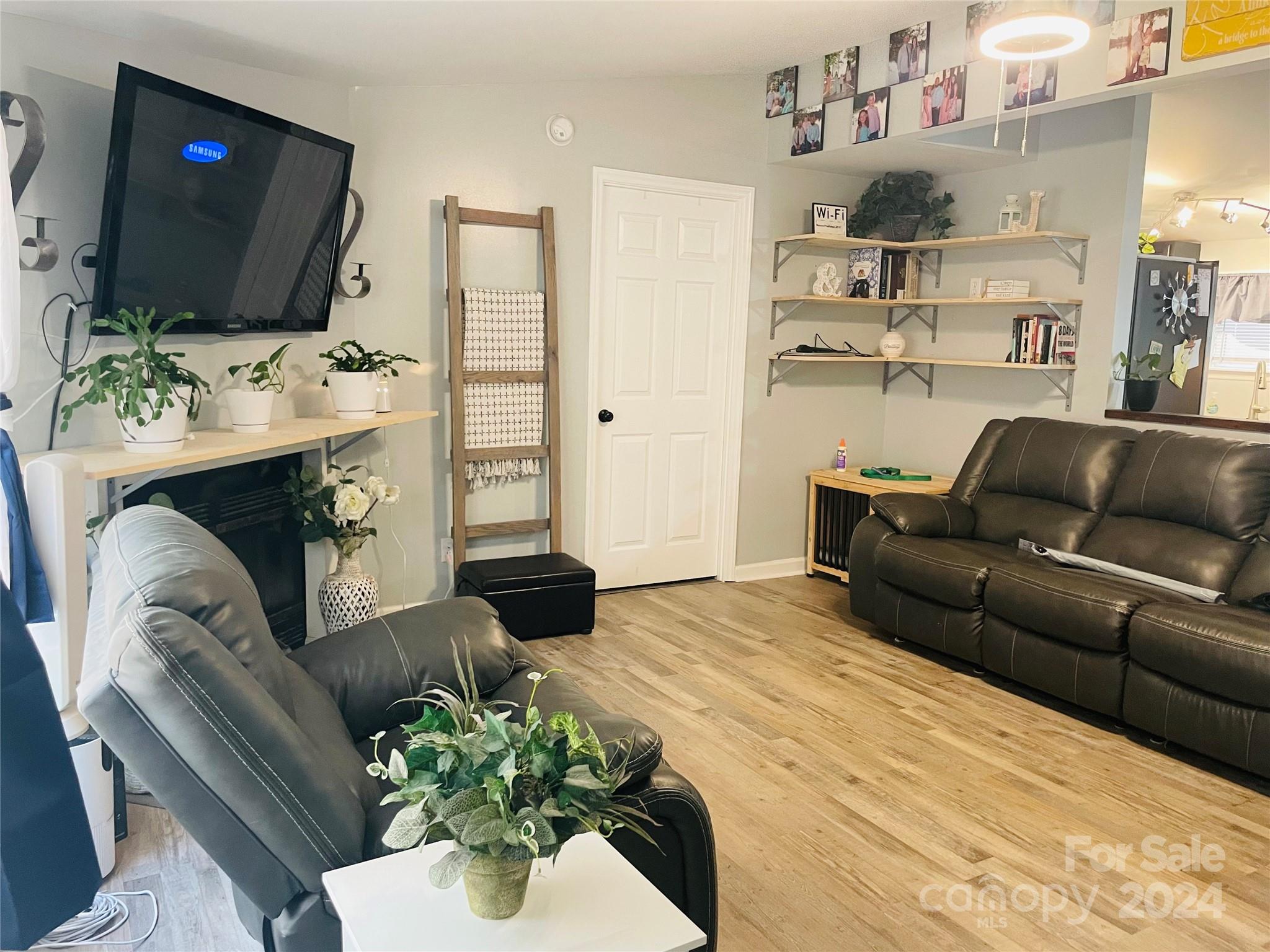 191 Old Hearth Road, Unit 29 Clover, SC 29710 - Photo 6 of 21 a living room with furniture a flat screen tv and a fireplace
