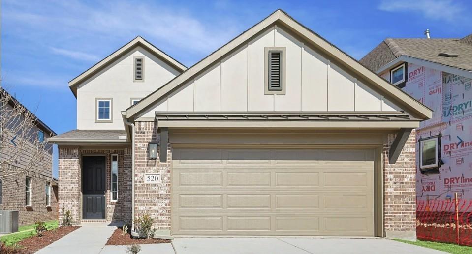 520 Weller Road McKinney, TX 75069 - Photo 1 of 12 View of front facade with concrete driveway, brick siding, and board and batten siding