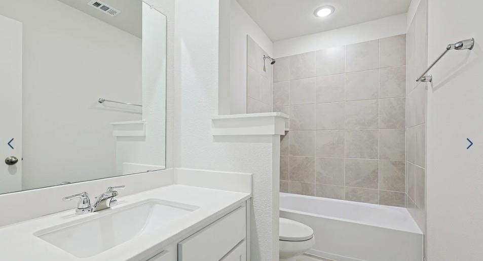 520 Weller Road McKinney, TX 75069 - Photo 3 of 12 Bathroom with toilet, vanity, washtub / shower combination, and recessed lighting