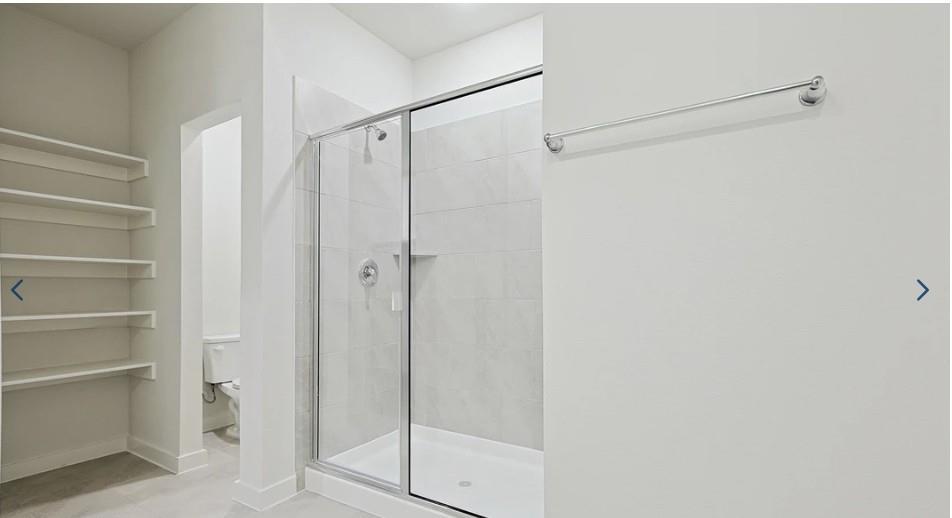 520 Weller Road McKinney, TX 75069 - Photo 5 of 12 Full bath featuring a shower stall, toilet, and baseboards