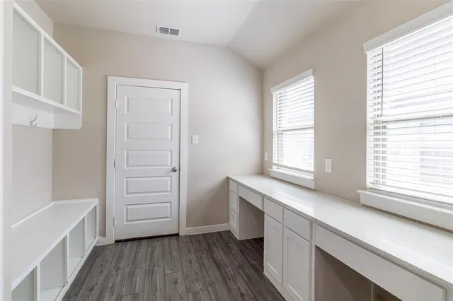 a view of kitchen with wooden floor and electronic appliances