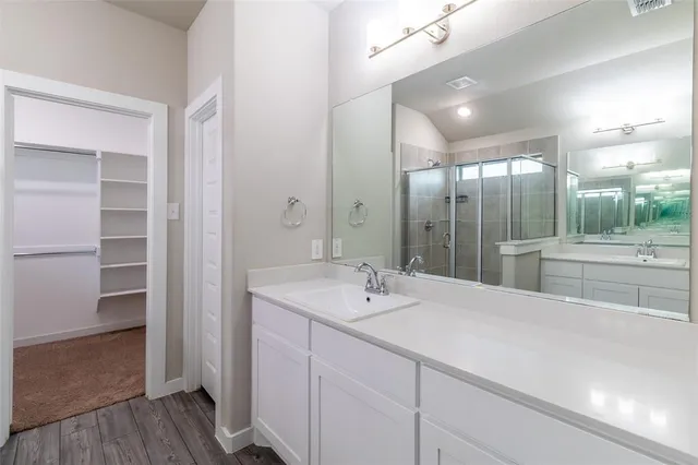 a bathroom with a sink double vanity and a mirror