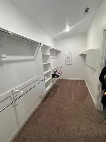 a view of a room with gym equipment and a fireplace