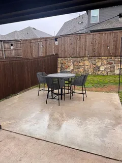 a view of a chairs and table in patio
