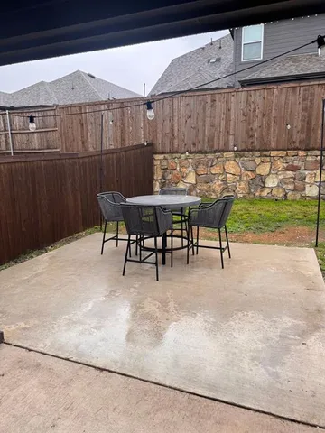 a view of a chairs and table in patio