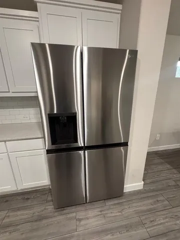 a refrigerator freezer sitting inside of a kitchen