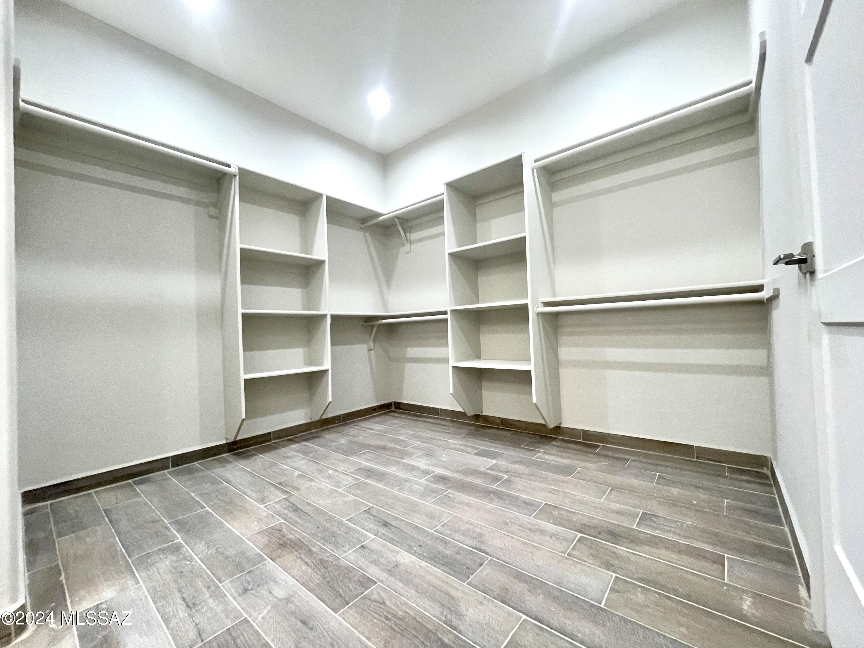 1049 Camino Estrella Rio Rico, AZ 85648 - Photo 17 of 28 a room with walk in closet and wooden floor